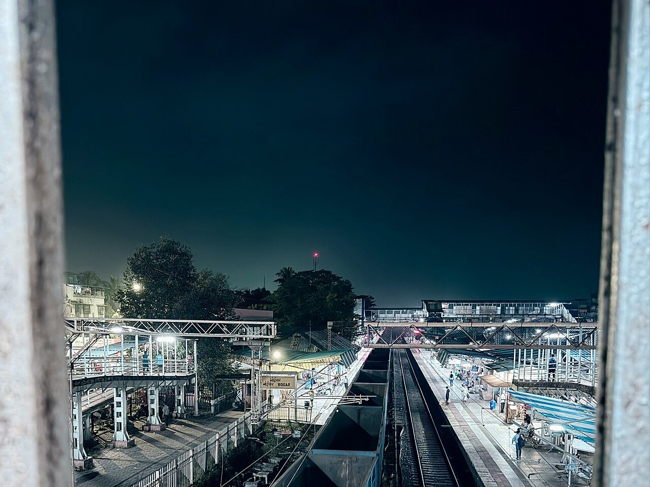 Containers stacked at an Indian port with a freight train alongside