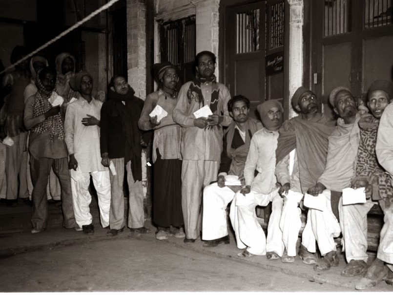 Voters queue at a polling station in Delhi in 1952