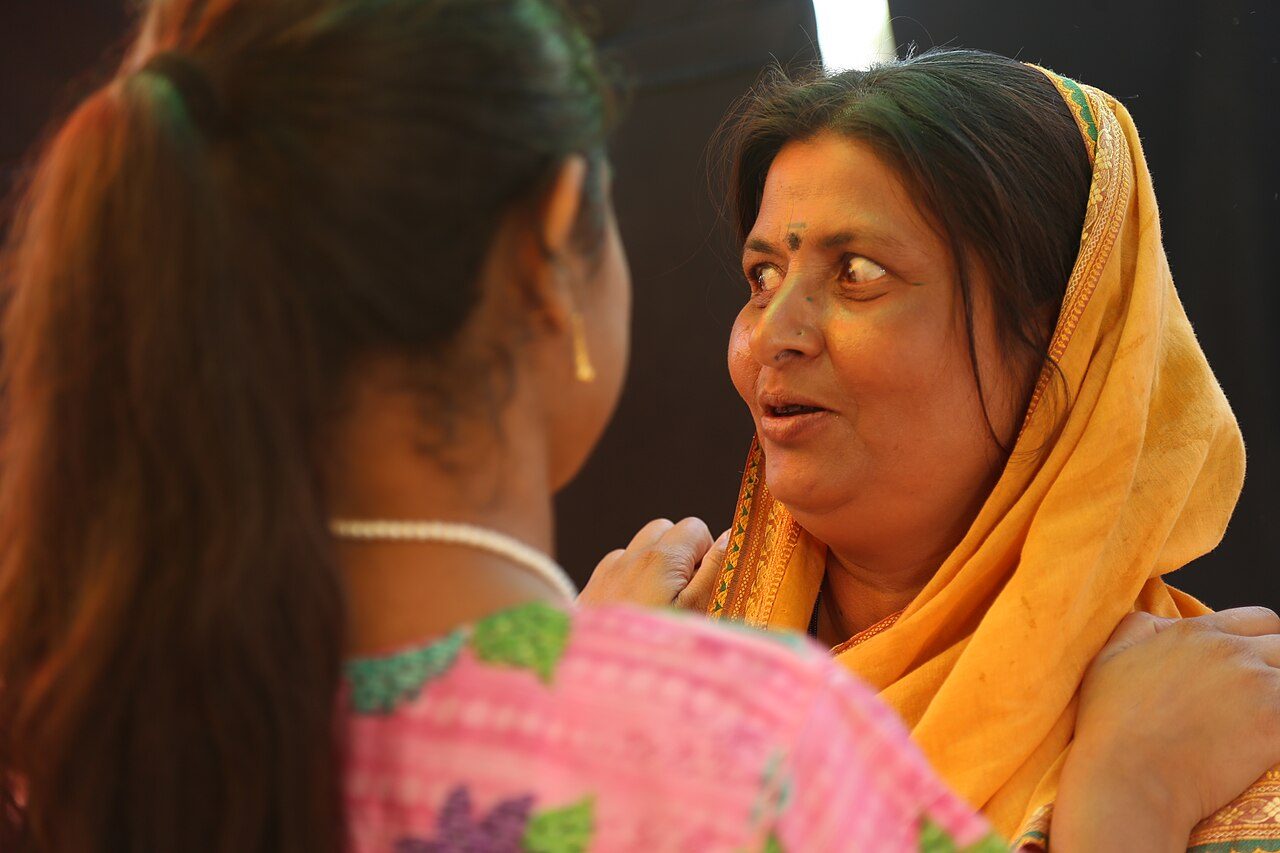 A census enumerator speaking to a family at their home